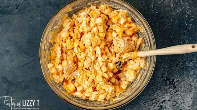 cheesy potatoes and chicken in mixing bowl