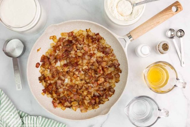 bacon and onions in a frying pan