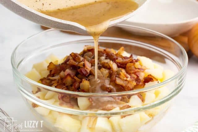 pouring dressing over bacon and potatoes