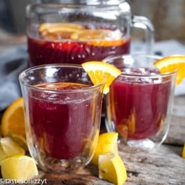 cups of Grape Juice Lemonade with orange quarters