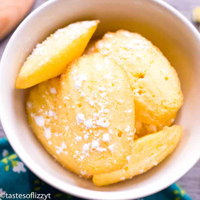 white bowl filled with lemon madeleine cookies