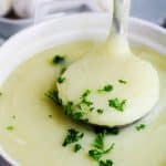 bowl of potato leek soup with ladle