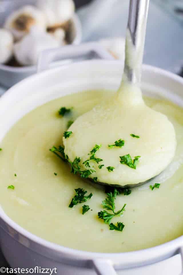 bowl of potato leek soup with ladle