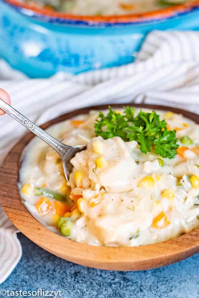 Chicken and Dumplings in a wooden bowl with garnish