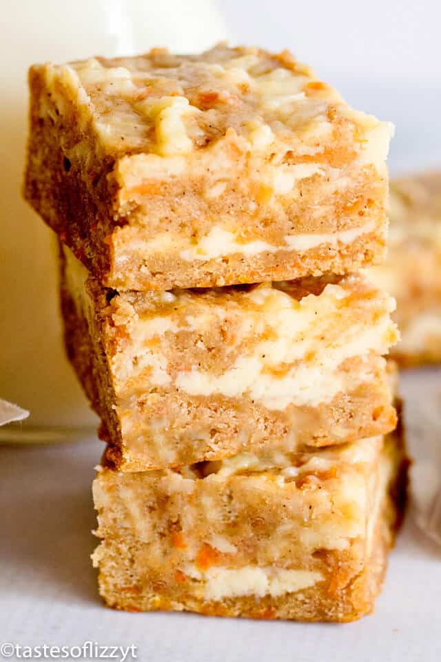 a stack of carrot cake bars with cheesecake swirl