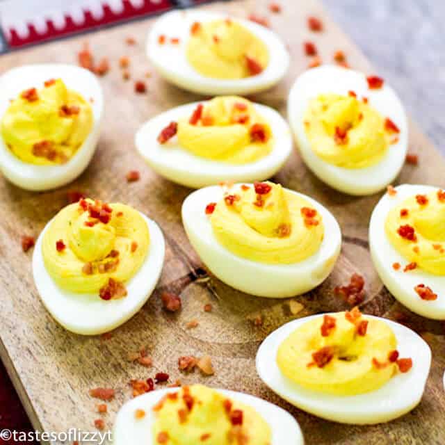 deviled eggs on wooden cutting board