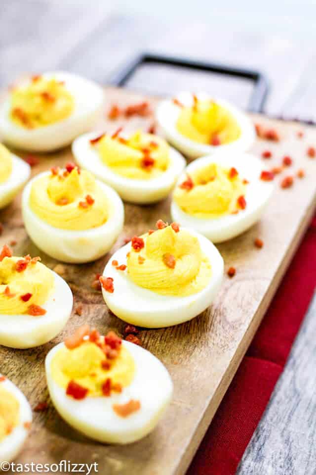 deviled eggs on wooden cutting board