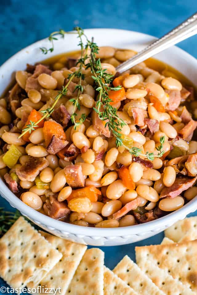 A bowl of food, with Ham and beans