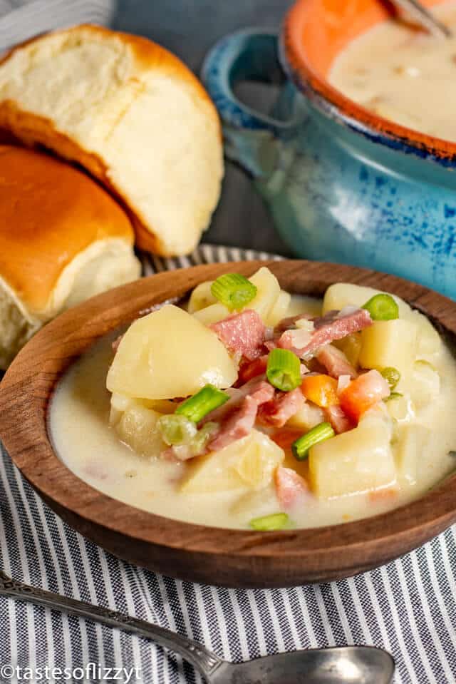 Ham and Potato Soup in wood bowl with rolls