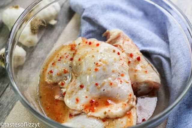 chicken thighs marinating in Italian salad dressing