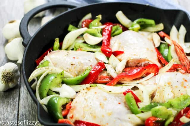 cooking an Italian chicken skillet meal in a cast iron pan