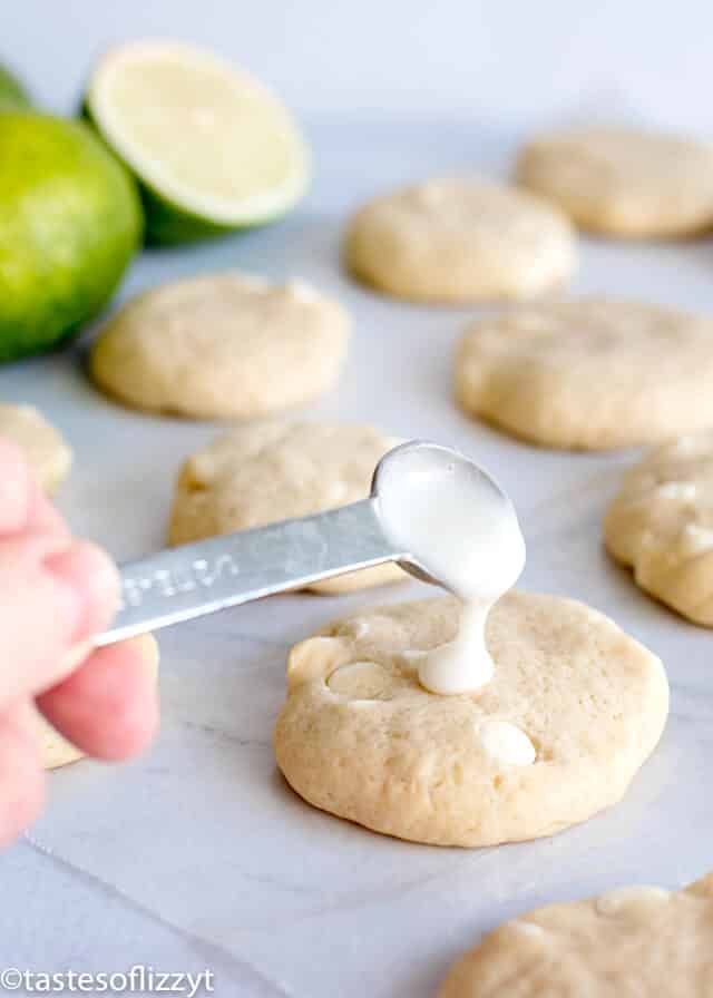 adding lime glaze to the top of key lime sugar cookies