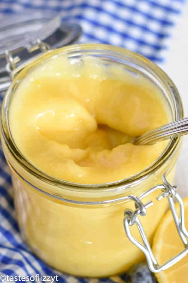 mason jar of lemon curd with a spoon in it