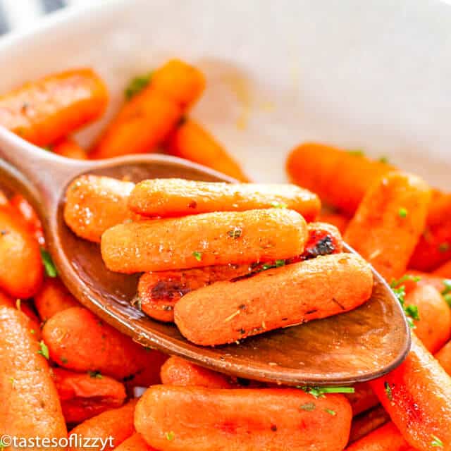 roasted baby carrots on a serving spoon