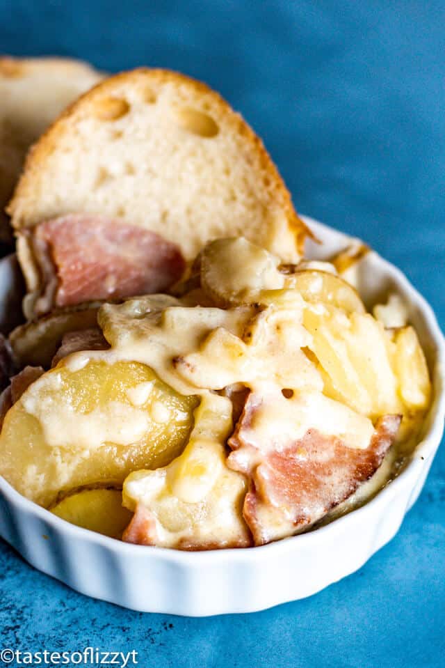 Scalloped Potatoes and Ham Recipe in bowl with bread