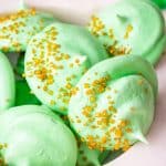 closeup of St Patrick's Day Meringue Cookies with gold sprinkles