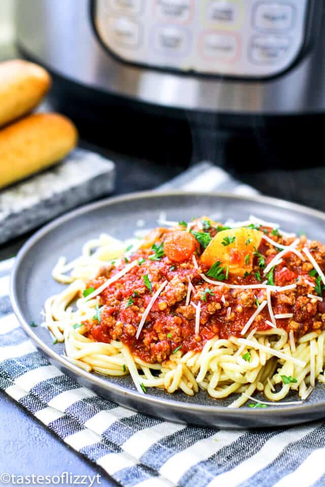 A plate of pasta on a table, with Sauce