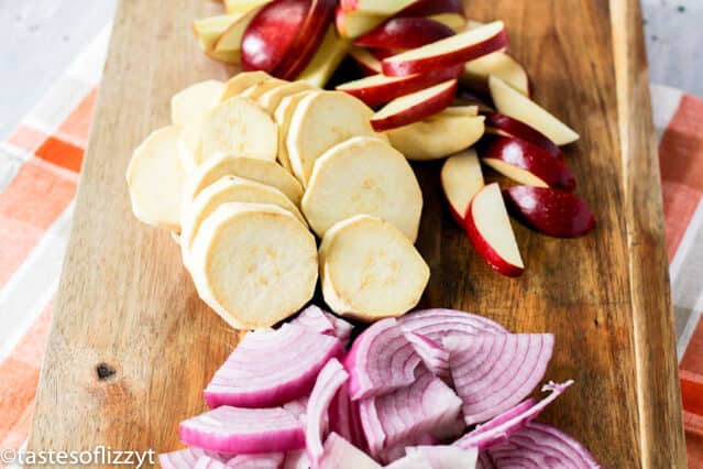 apples, onions and potatoes on a wooden table