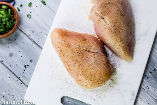 chicken breasts on a cutting board