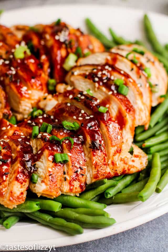 A close up of a plate of food with beans, with Chicken and Sauce