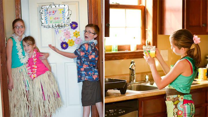 a boy with a sign and a girl in the kitchen