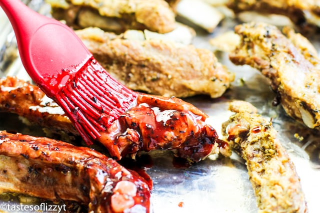 brushing bbq sauce on ribs