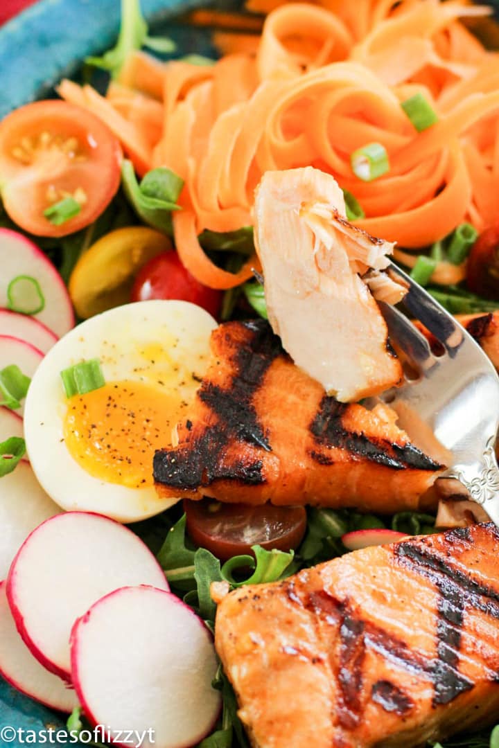 A plate of food, with Salmon and vegetables