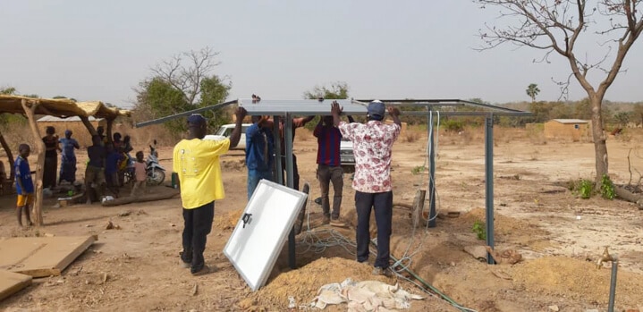 A group of people standing in the dirt