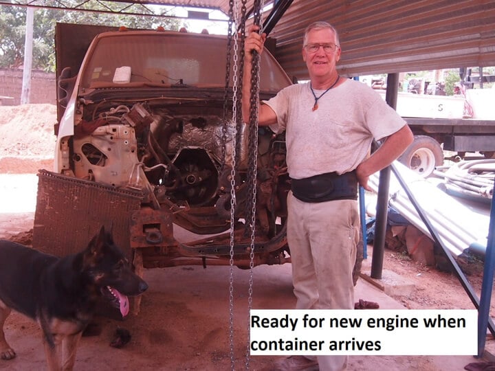 A man standing next to a dog