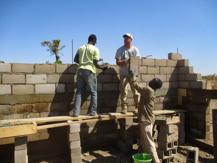 men working on buidling a building
