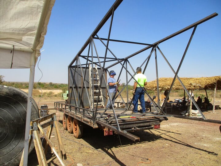 two men on the back of a work truck