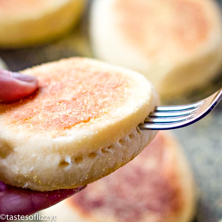 fork poking holes in english muffin