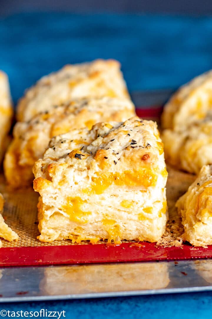 closeup of biscuits sitting on a baking mat