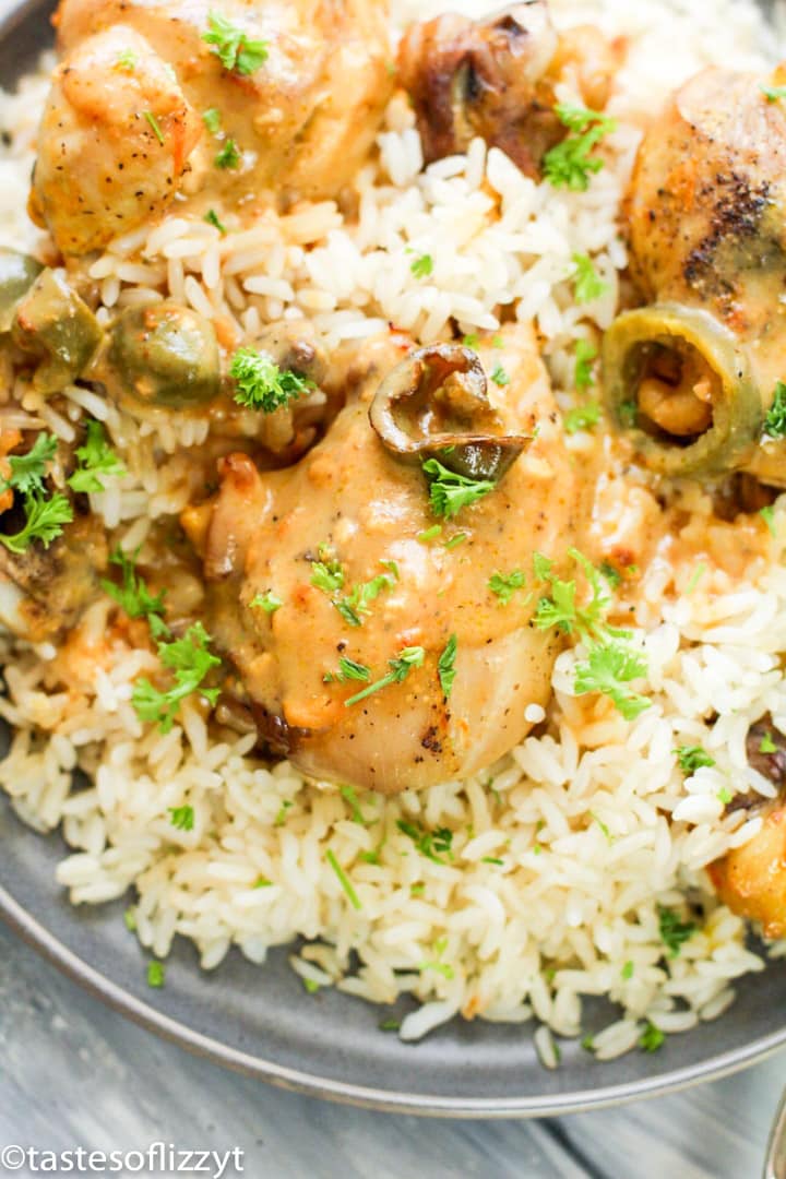 A close up of a plate of food with Chicken and Rice