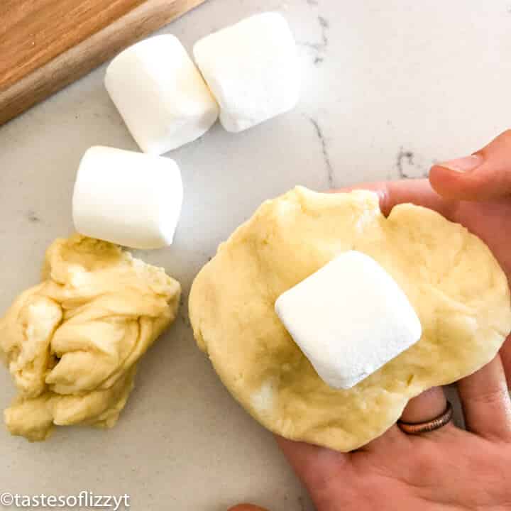 folding a marshmallow into dough