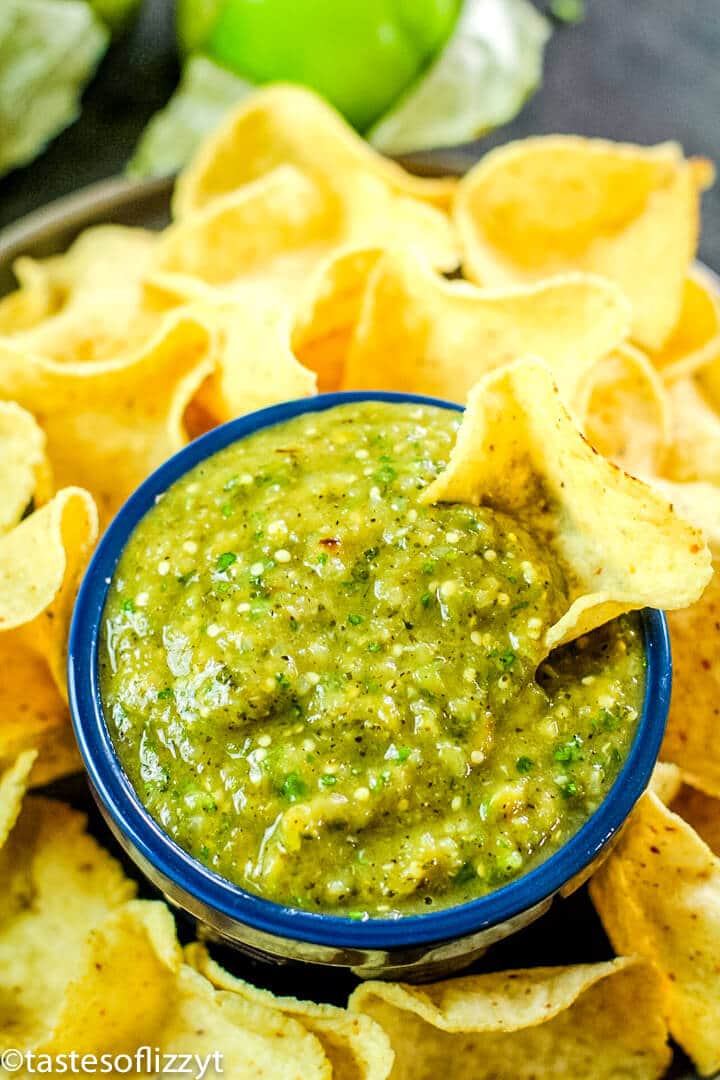 a bowl of salsa verde with chips
