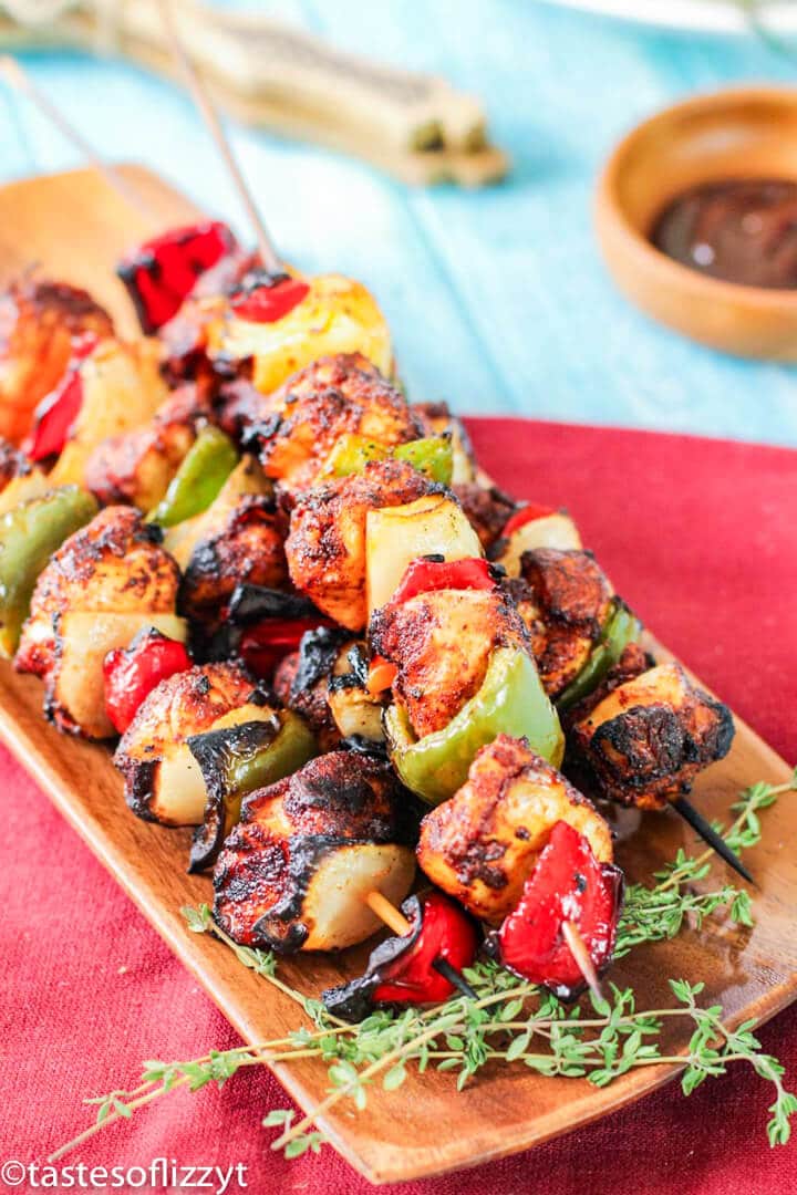 A plate of food on a table, with Skewer and Kebab