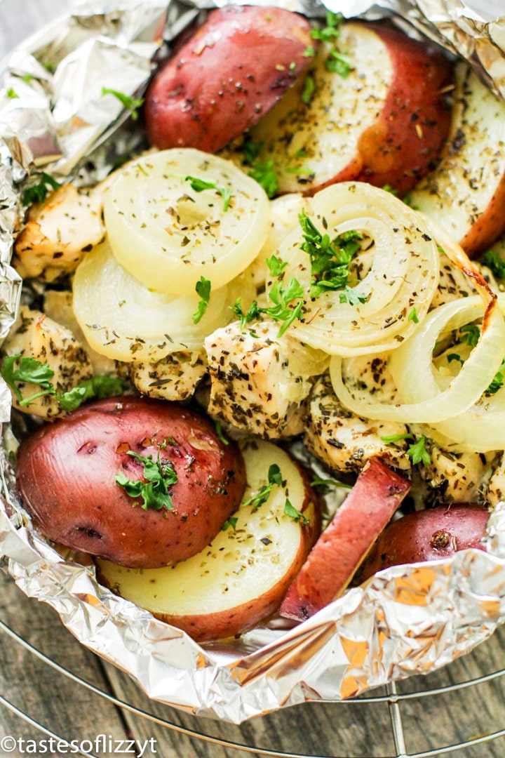 A close up of food, with onions, chicken and Potato