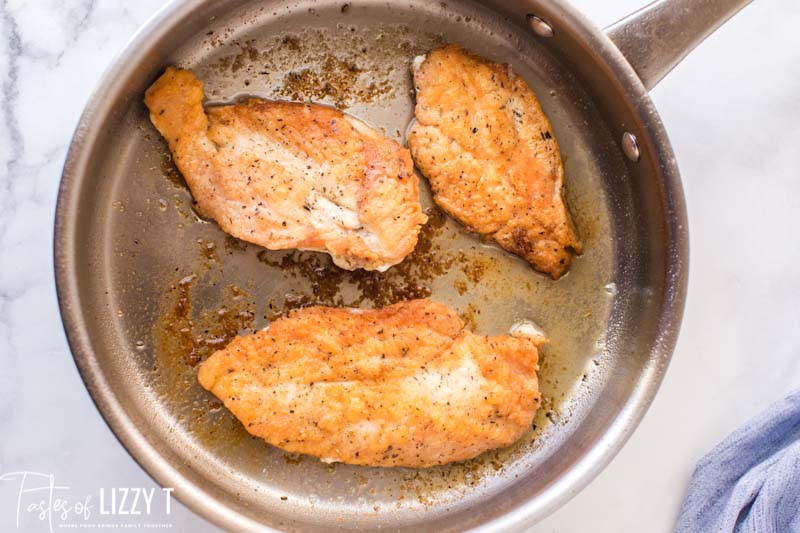 chicken frying in a pan