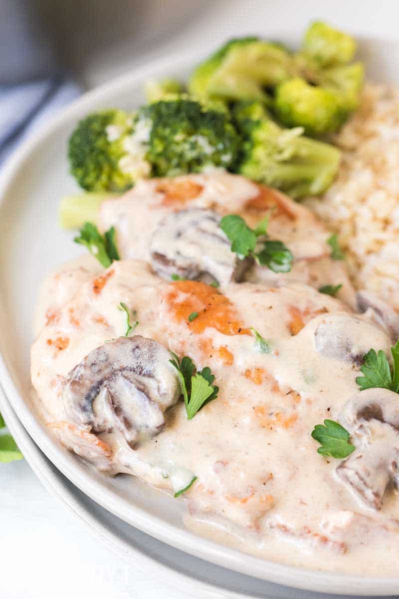 A plate of food with broccoli, with Chicken marsala