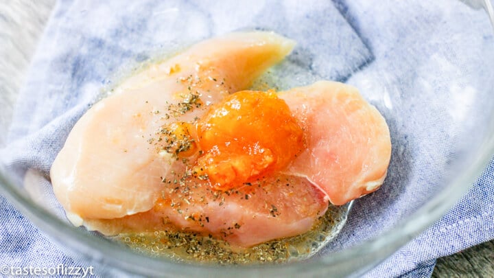 chicken marinating in a bowl