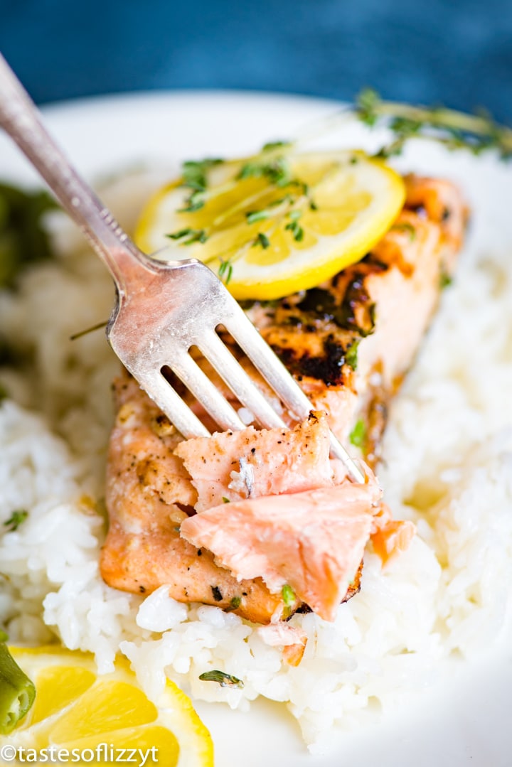 A plate of food with rice and vegetables, with Salmon