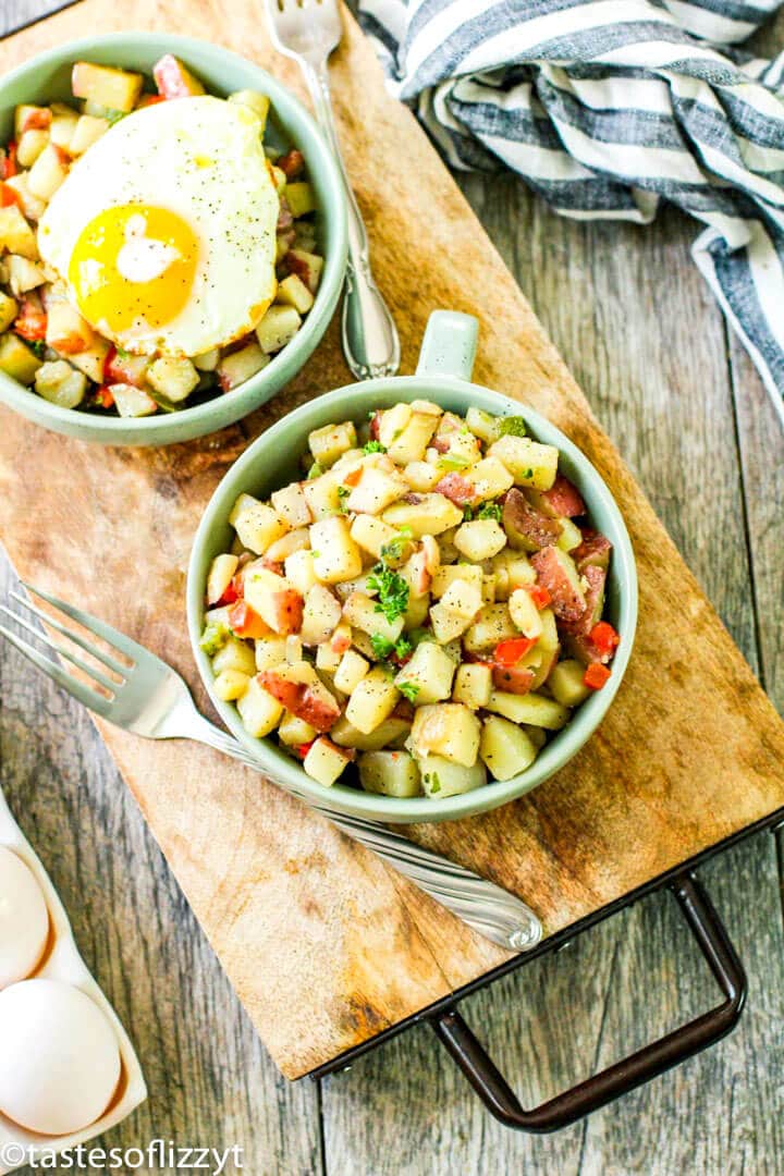 A bowl of food on a table, with Potatoes O\'Brien