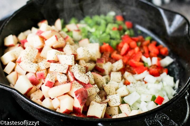 A pan filled with potatoes, peppers and onions