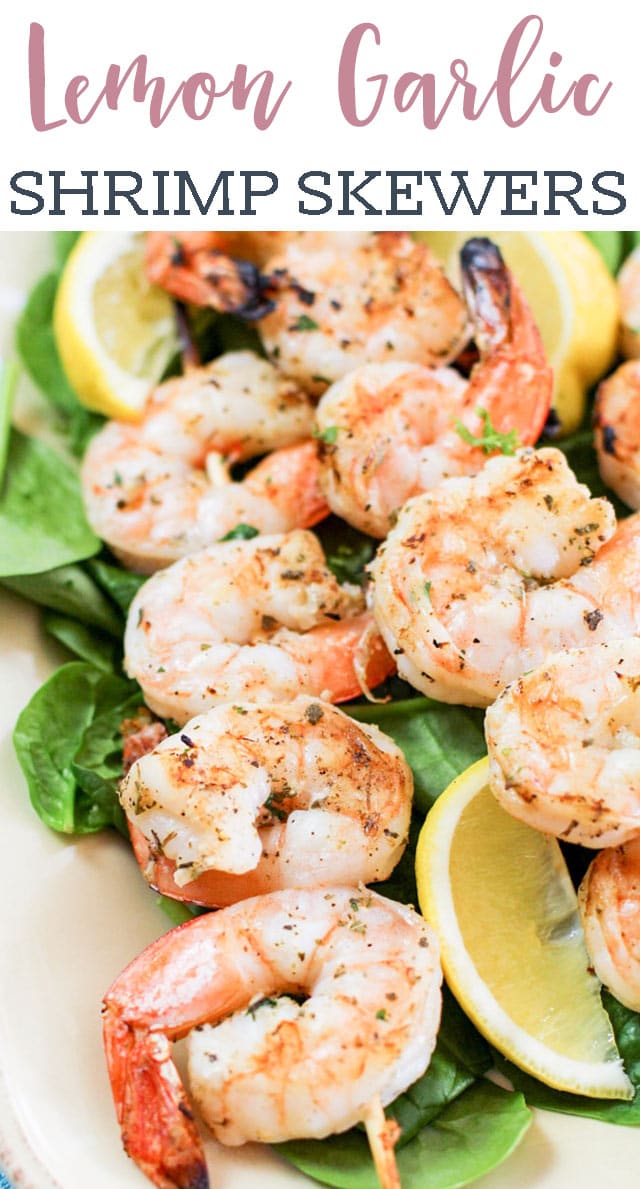 A plate of shrimp and vegetables, with Lemon and Skewer