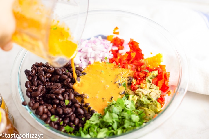 dressing pouring over a salad