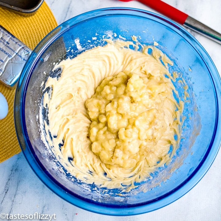 folding bananas into bread batter