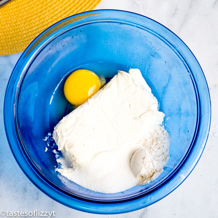 egg, sugar and cream cheese in bowl