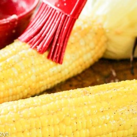 brushing butter on ear of corn