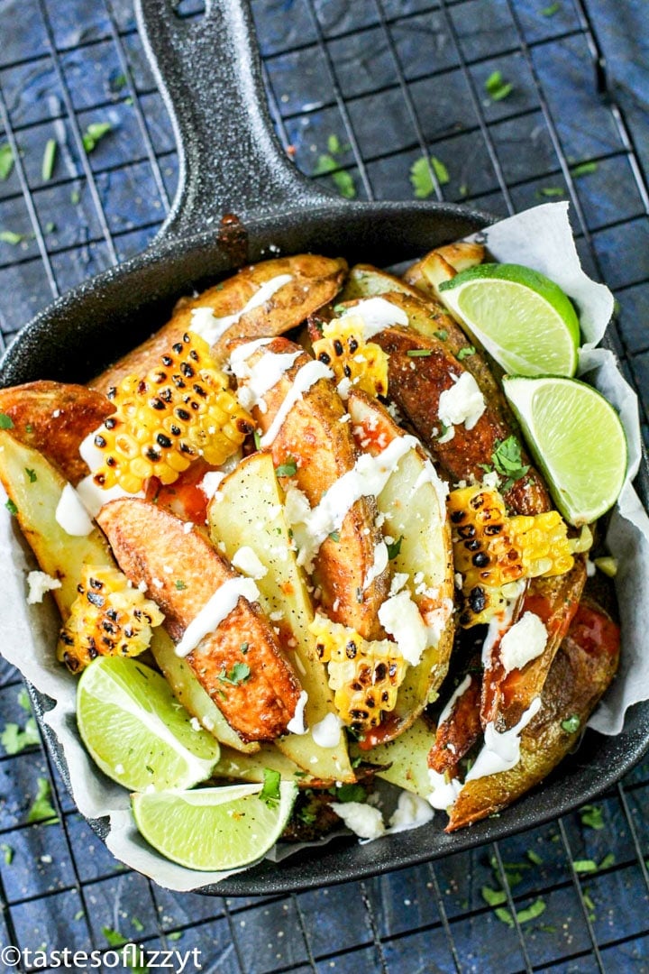 A close up of food in a skillet with Potato wedges